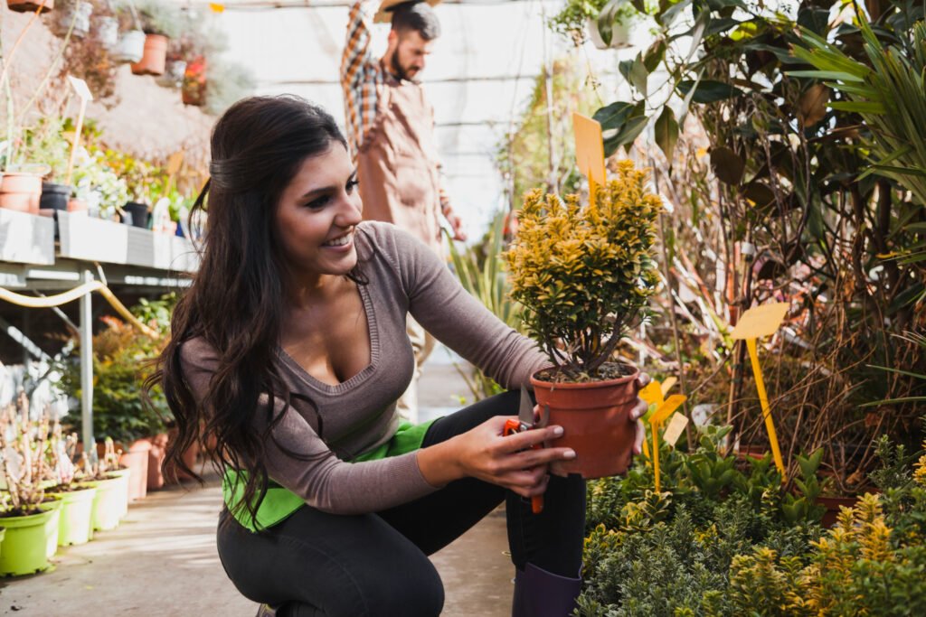 mujer sosteniendo plantas de su jardin sostenible con plantas locales de España
