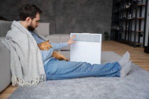 hombre poniéndose caliente en invierno con un covertis y uno de los sistemas de climatización para vivendas